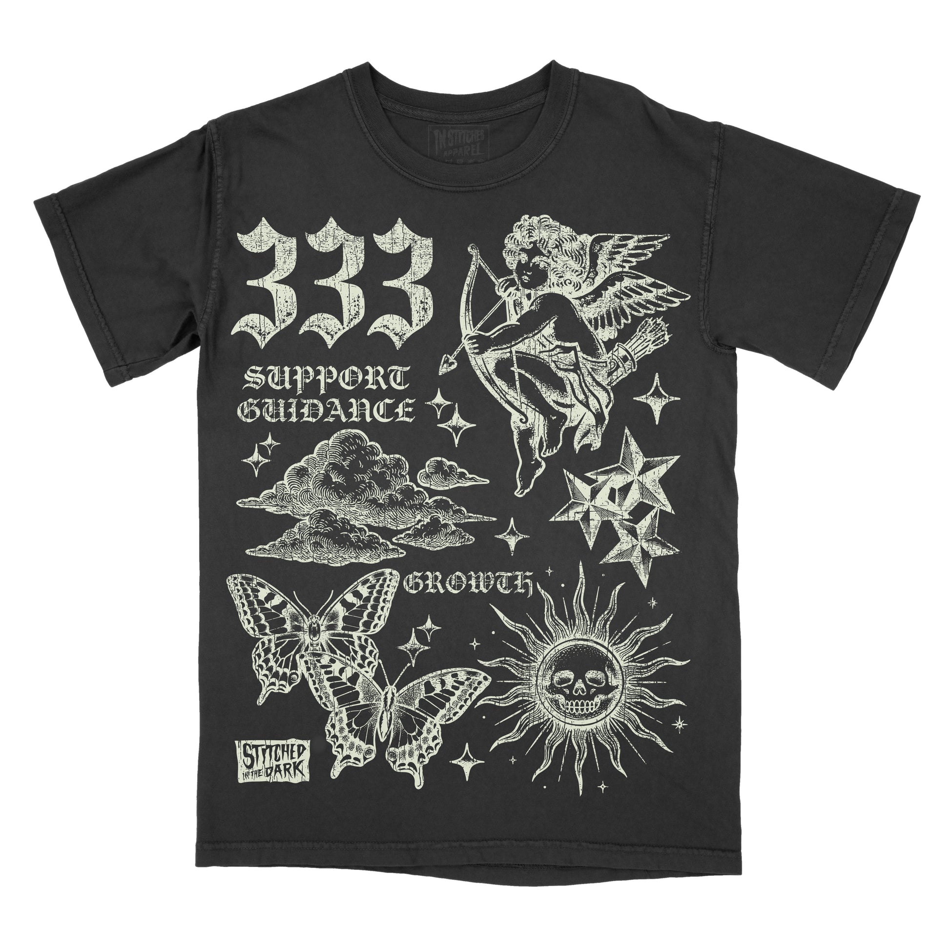 black T-shirt featuring a distressed 333 angel number design with a cherub, butterflies, clouds, stars, and a skull sun, with text reading “Support Guidance” and “Growth” and Stitched in the Dark branding.