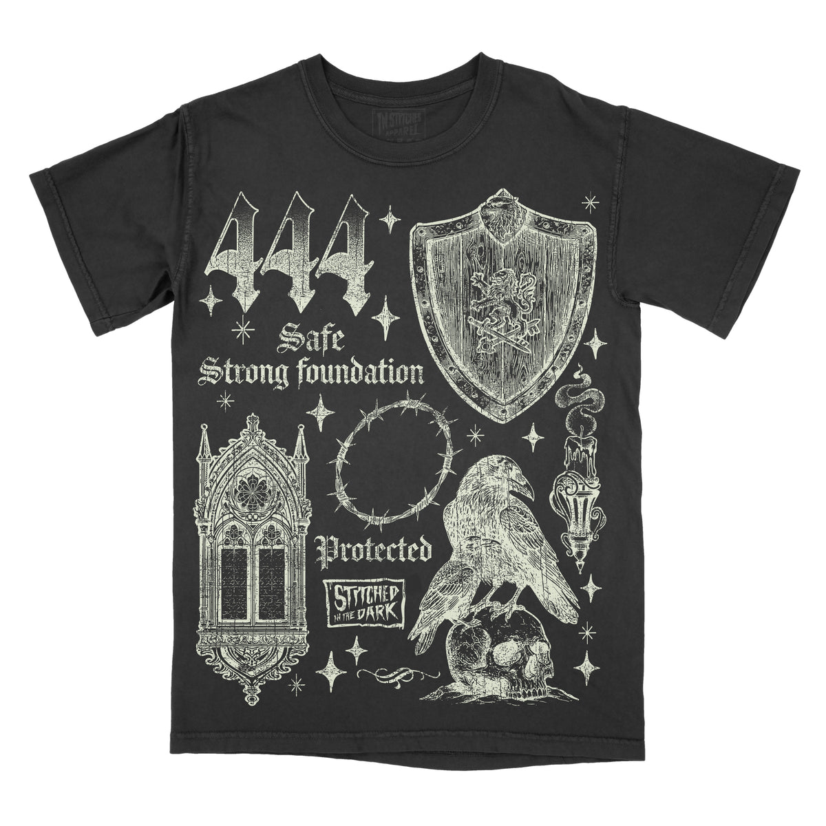 black T-shirt featuring a distressed 444 angel number design with a medieval shield, gothic window, barbed wire halo, raven perched on a skull, and candle, with text reading “Safe,” “Strong Foundation,” and “Protected,” plus Stitched in the Dark branding.