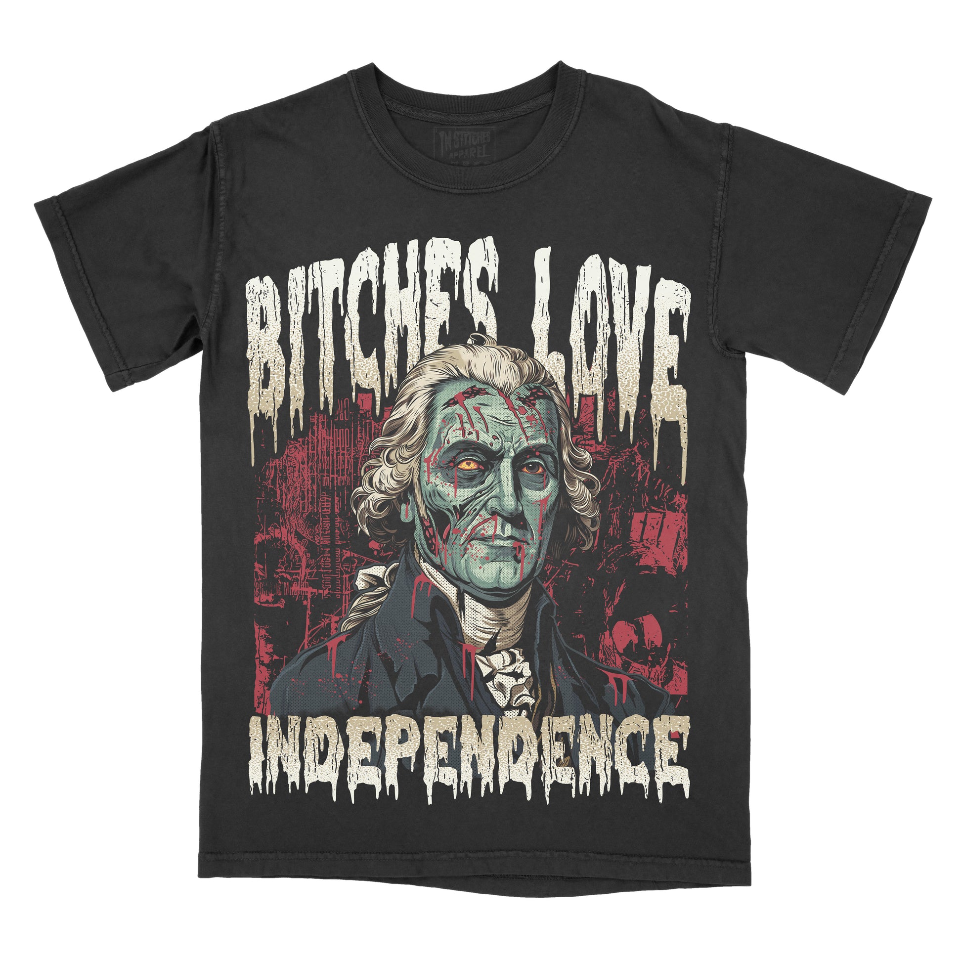 A black short-sleeve graphic t-shirt featuring a distressed print of George Washington with zombie-like green skin, the text 'BITCHES LOVE INDEPENDENCE' in a dripping white font, and a red cityscape background.