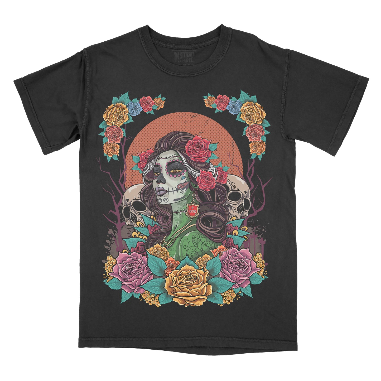 A black short-sleeve t-shirt with a colorful Day of the Dead (Dia de los Muertos) graphic print featuring a sugar skull woman, roses, skulls, and a large orange sun.