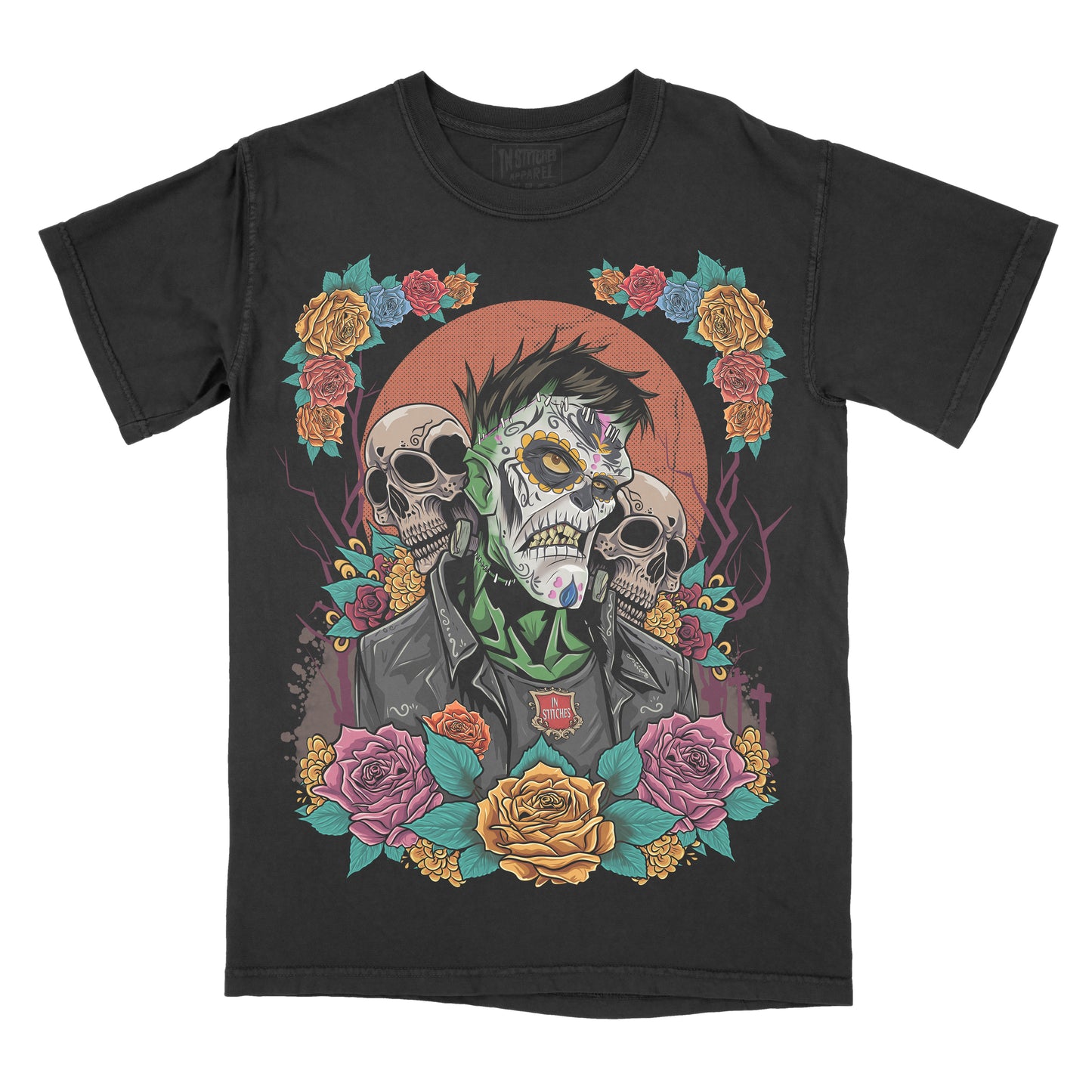 Black garment-dyed graphic t-shirt featuring an original Frankenstein-inspired Day of the Dead design with sugar skull details, colorful floral artwork, and gothic horror aesthetics.