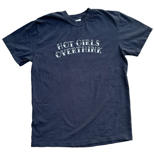 A black short-sleeve t-shirt with the phrase 'HOT GIRLS OVERTHINK' embroidered in a white, stylized font across the chest, displayed flat against a white background.