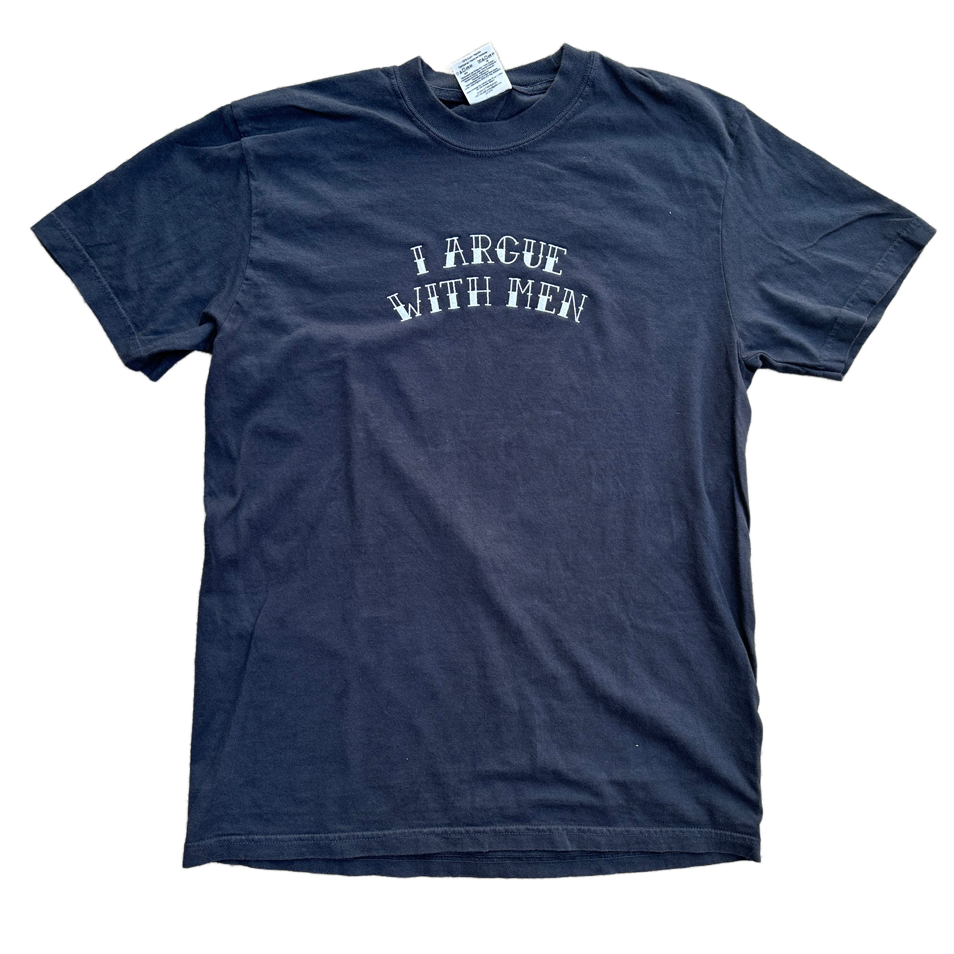 A black short-sleeve t-shirt with the phrase 'I ARGUE WITH MEN' embroidered in white arched text across the chest, laid flat on a white background.