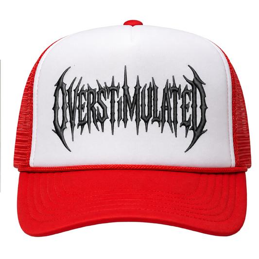A red and white trucker hat featuring a white front panel with a black spiky metal-style logo that reads 'OVERSTIMULATED' across the center, red mesh side panels, and a red curved brim.