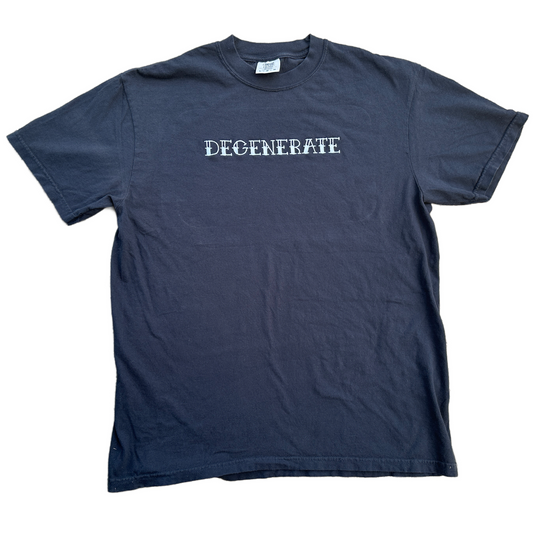 A black short-sleeve t-shirt with the word 'DEGENERATE' embroidered in white letters across the chest, laid flat against a white background.