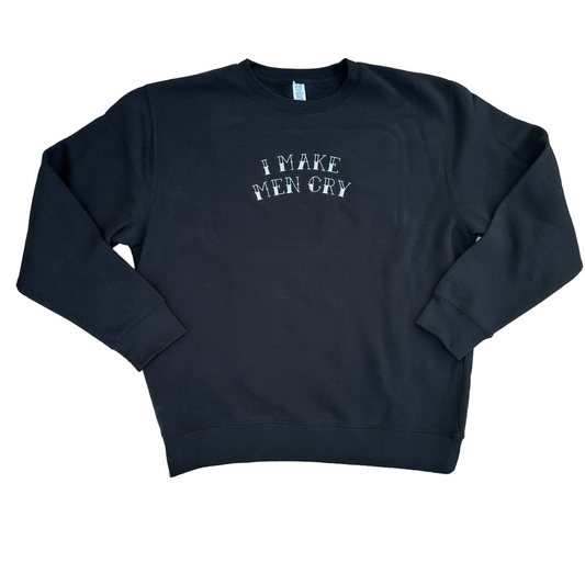 Black crewneck sweatshirt featuring white embroidered text across the chest that reads “I Make Men Cry” in a distressed vintage-style font, shown on a white background.