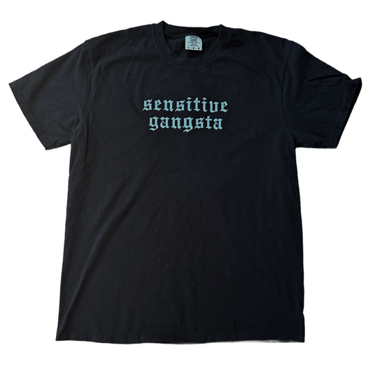 Black Comfort Colors T-shirt featuring white embroidered Old English text across the chest that reads “Sensitive Gangsta.”