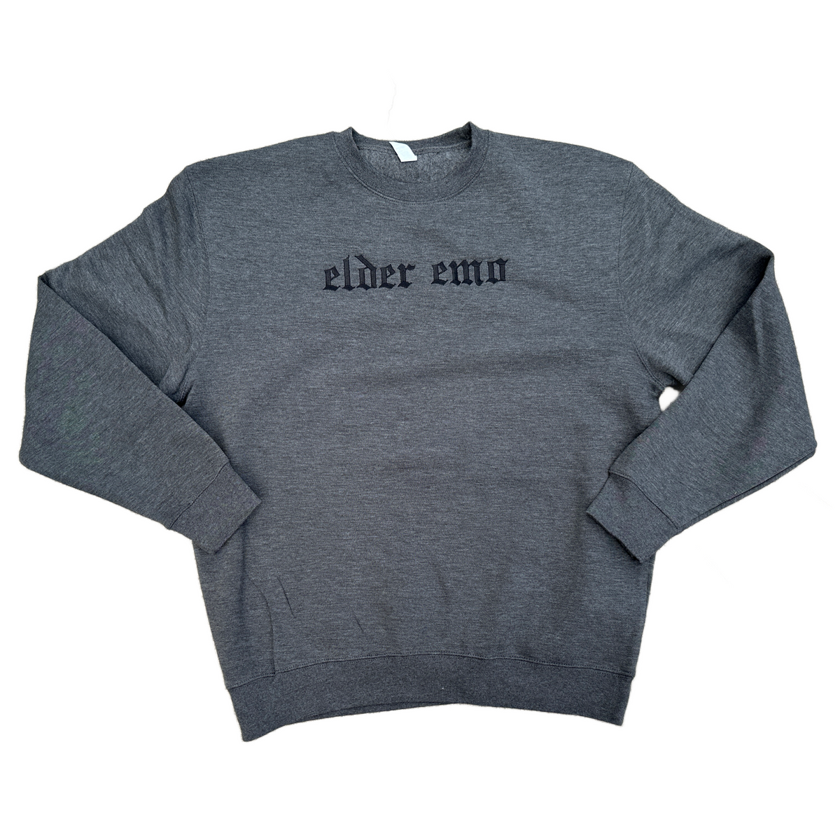 Charcoal gray crewneck sweatshirt featuring black embroidered Old English text across the chest that reads “elder emo.