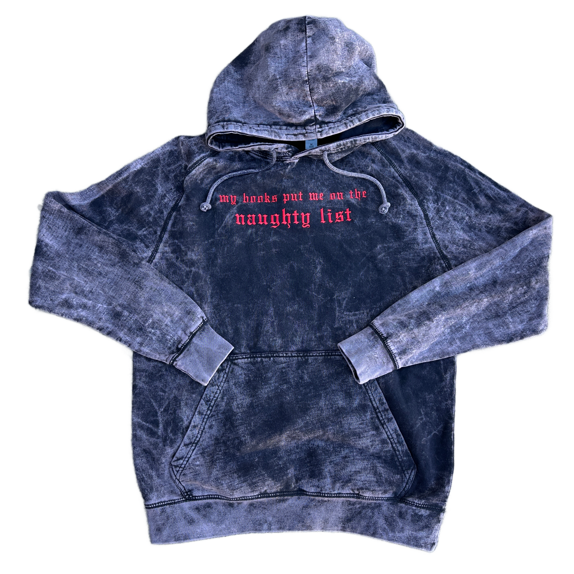 Vintage cloud black mineral-washed hoodie featuring bright red embroidered Old English text across the chest that reads “my books put me on the naughty list,” with a drawstring hood and front kangaroo pocket.