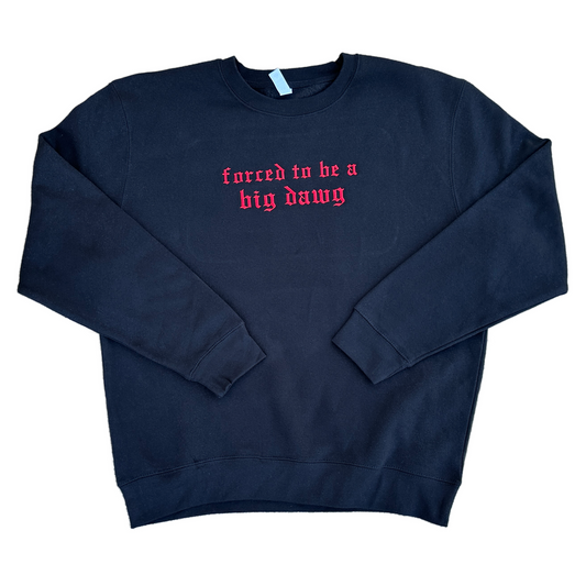 Black crewneck sweatshirt featuring red Old English embroidered text across the chest reading “forced to be a big dawg,” shown flat on a white background.
