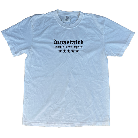 Comfort Colors T-shirt featuring black Old English embroidered text reading “devastated” with “would read again” underneath and five black stars across the chest.