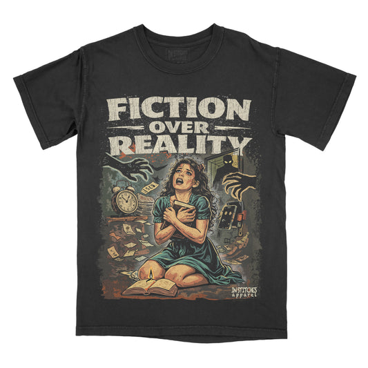 A black graphic t-shirt featuring a vintage-style illustration with the distressed text 'FICTION OVER REALITY'. The graphic depicts a woman in a teal dress sitting on the floor surrounded by books, a clock, and hands, with a small 'In Stitches Apparel' logo in the bottom right corner of the print.