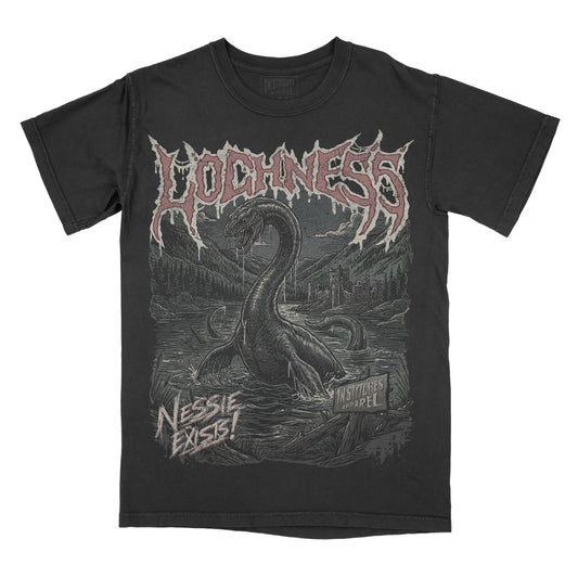 A black short-sleeve graphic t-shirt featuring a large front print of a Loch Ness serpent rising from water, with the word 'LOCHNESS' in a jagged metallic-style font across the chest and 'NESSIE EXIST!' near the lower left.