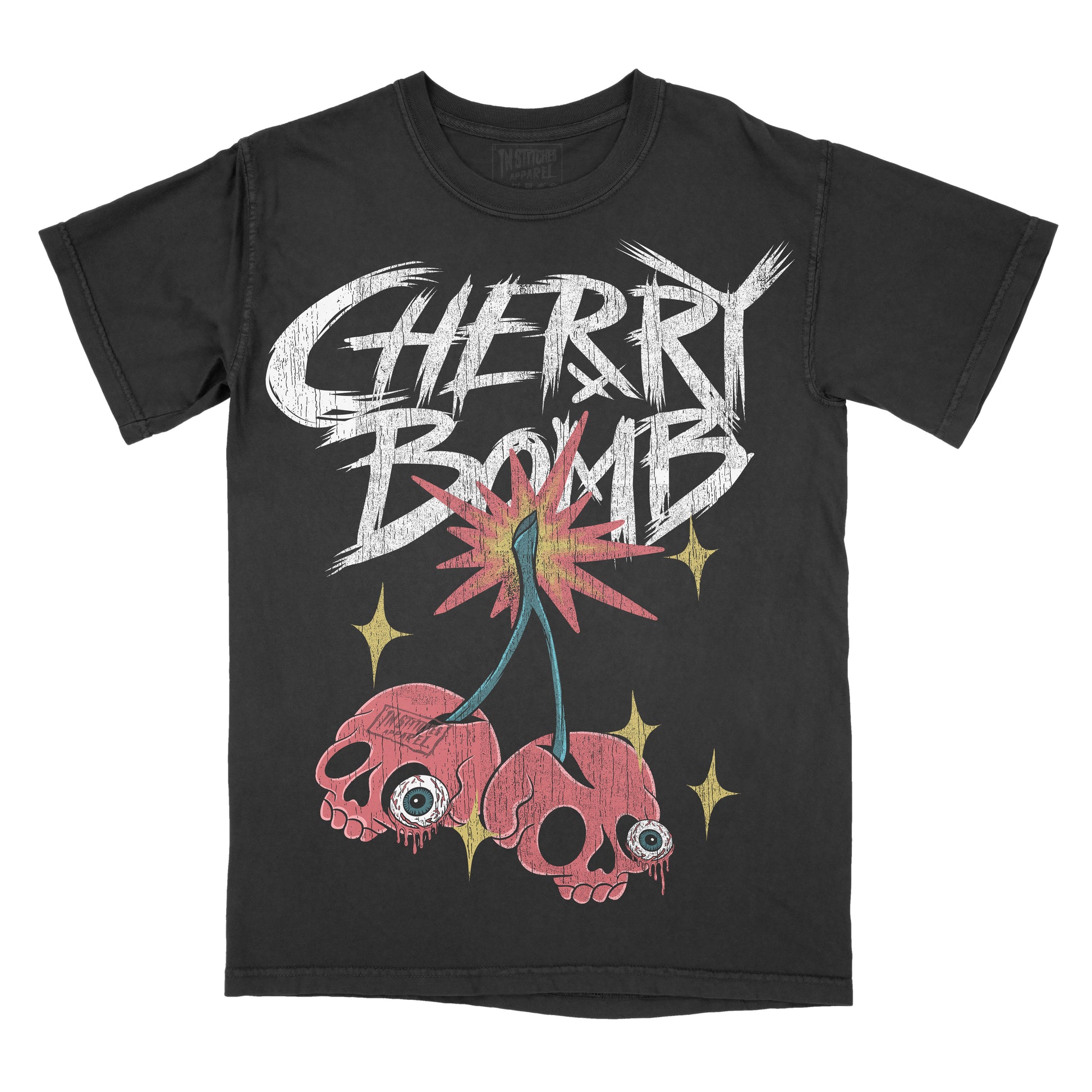A black short-sleeve graphic t-shirt featuring the text 'CHERRY BOMB' in a distressed white brush font, above a two red cherry skulls and yellow stars.