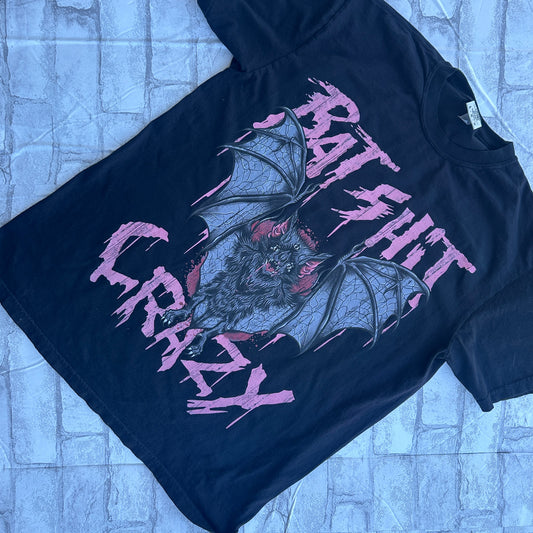 Black graphic tee with a design of bats and the text 'BAT SHIT CRAZY' in pink.