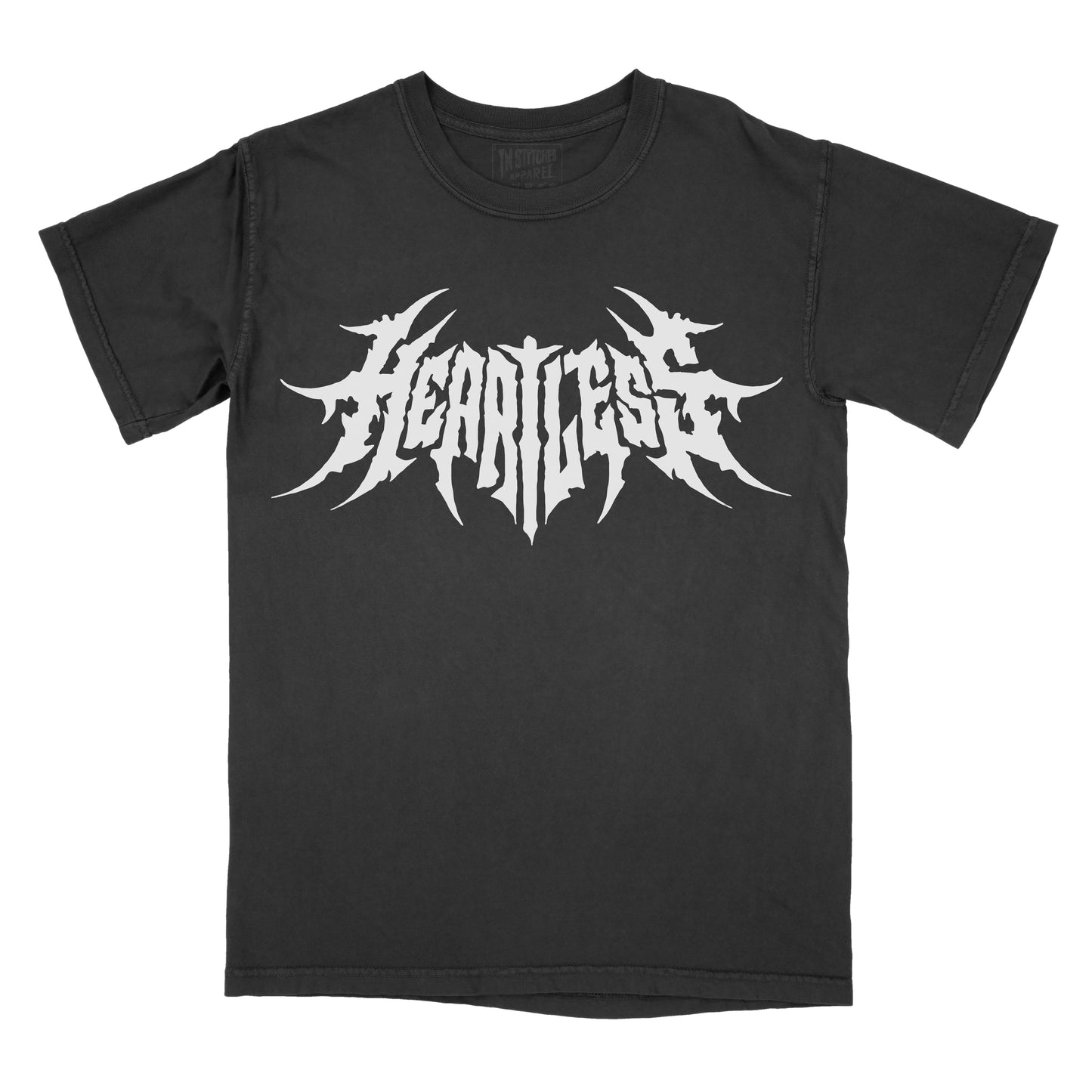Black T-shirt featuring the word "HEARTLESS" in a white heavy metal-inspired font with sharp, pointed lettering and a symmetrical design.