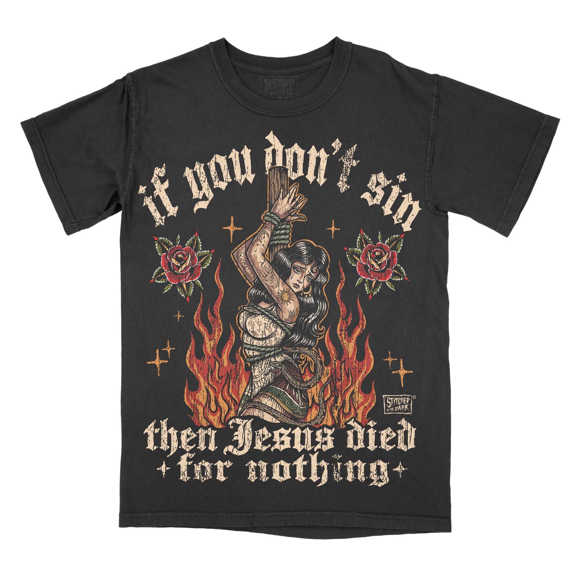 black T-shirt featuring a tattoo-style woman tied to a stake surrounded by flames and red roses, with distressed text reading “If you don’t sin then Jesus died for nothing” and Stitched in the Dark branding.