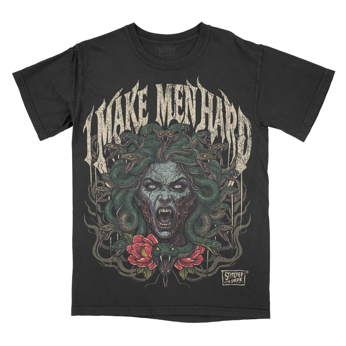 black T-shirt featuring a dark horror-style Medusa with green snakes for hair and red flowers, with distressed gothic text reading “I Make Men Hard” and Stitched in the Dark branding.