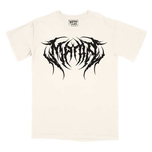 A cream graphic tee with the word 'MAMA' printed in a large, black, metal font across the chest.