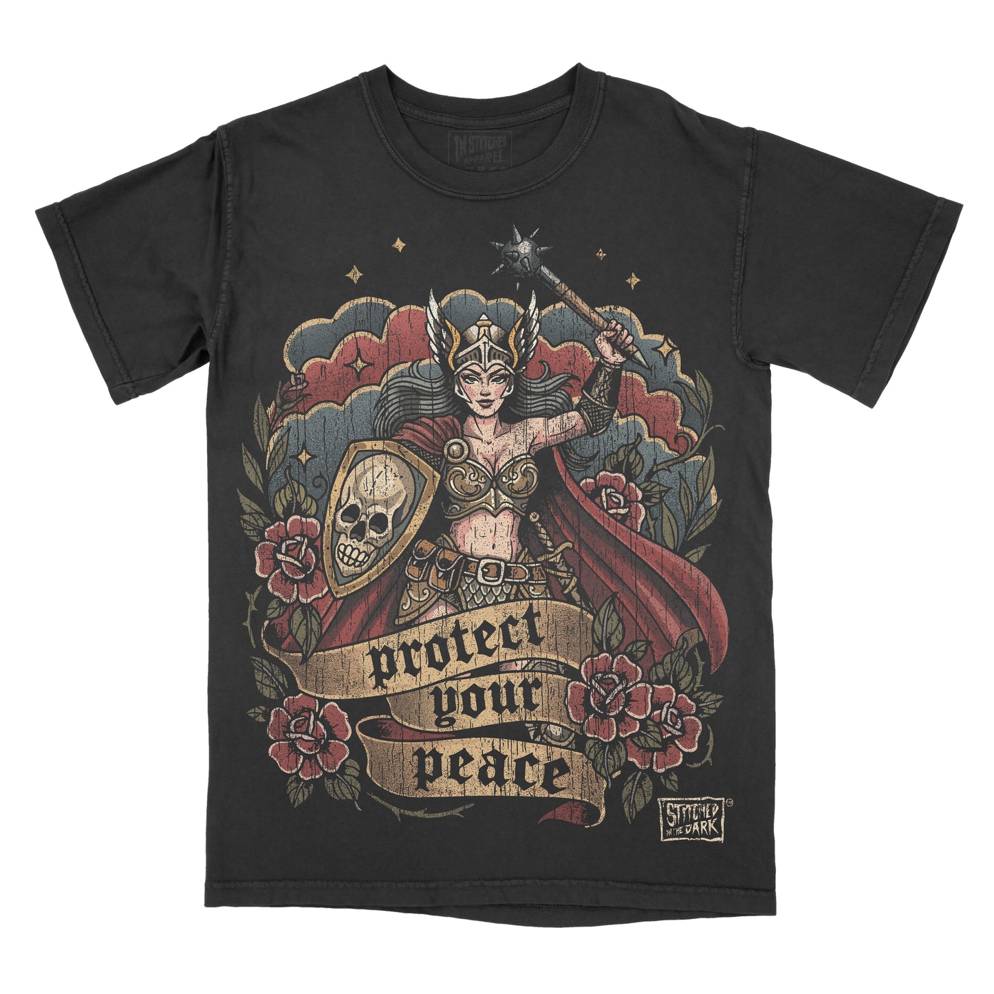 T-shirt featuring a distressed tattoo-style warrior woman holding a spiked mace and skull shield, surrounded by red roses, with a banner reading “Protect Your Peace” and Stitched in the Dark branding.