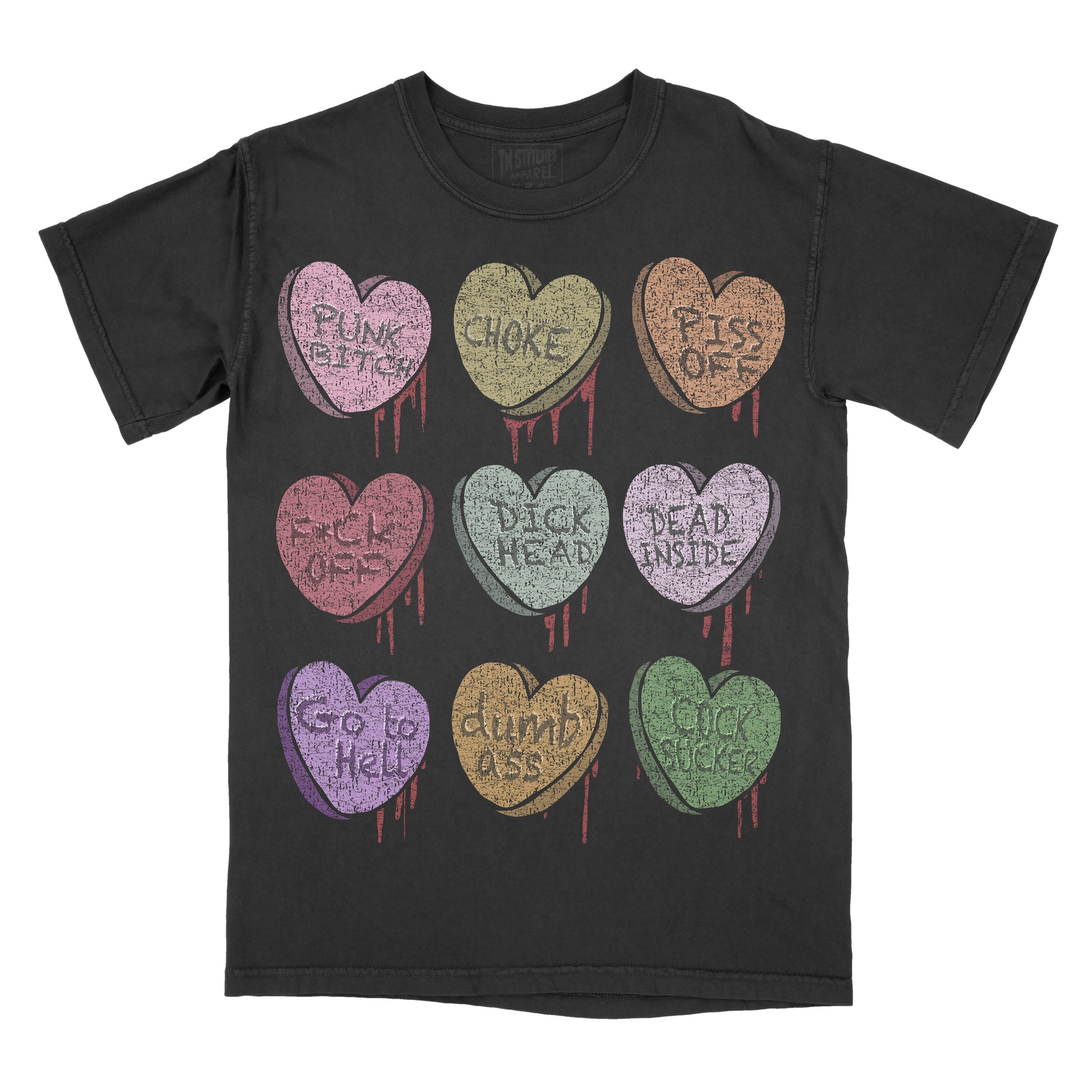 Black T-shirt featuring nine pastel conversation candy hearts arranged in a 3×3 grid. Each heart has a distressed vintage look with red dripping accents and contains a different phrase: "Punk Bitch," "Choke," "Piss Off," "Fuck Off," "I'd CK Instead," "Dead Inside," "Go to Hell," "Dumb Ass," and "Cock Sucker."